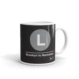 Classic Subway Logo Coffee Mugs | Ceramic mug with a light gray circle featuring a white "L". Text below reads: "Brooklyn to Manhattan." Perfect for fans of the NYC Subway Line.